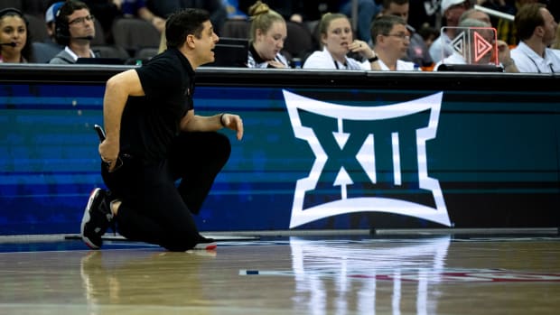 Cincinnati Bearcats head coach Wes Miller works the sideline in the second half of the Big 12 Conference tournament between Cincinnati Bearcats and West Virginia Mountaineers at T-Mobile Center in Kansas City, Mo., on Tuesday, March 12, 2024.  